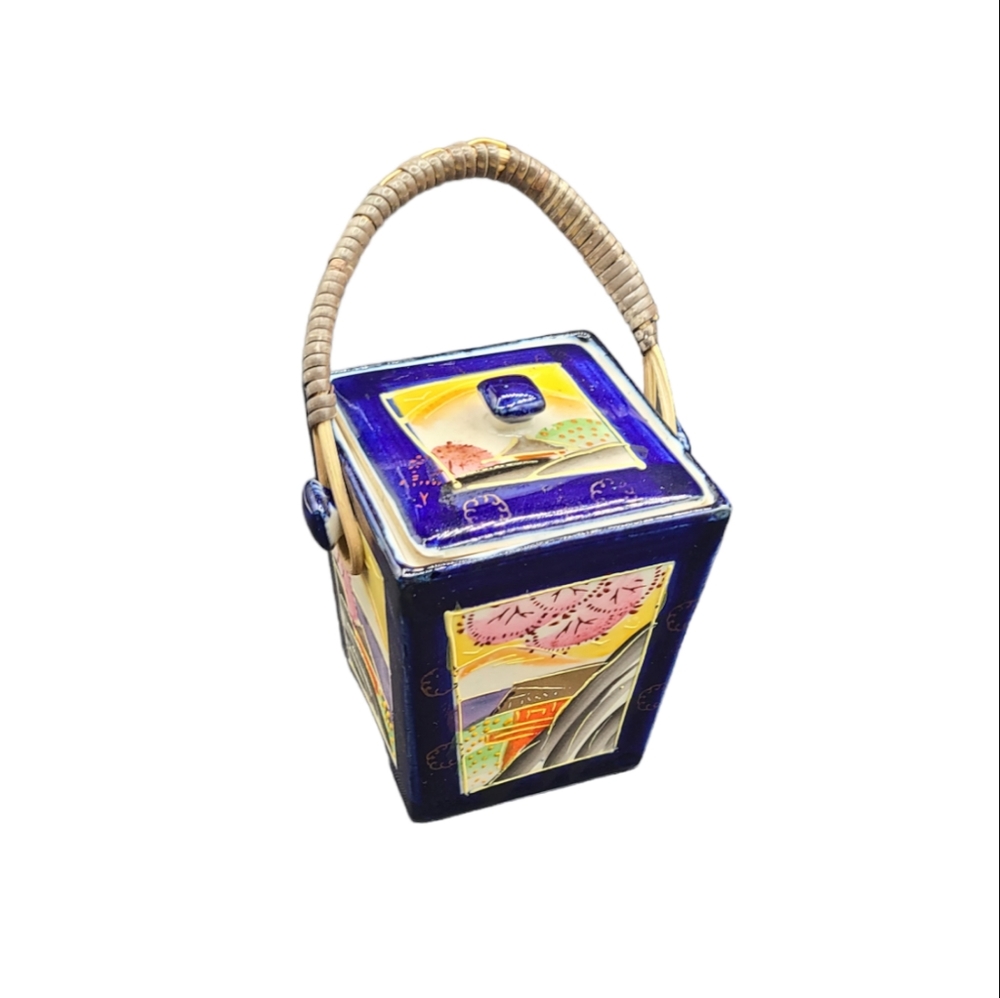 Antique hand painted Japanese ceramic box with lid and bamboo handle.